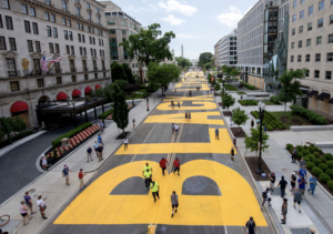 Nestled along a charming two-block pedestrian stretch of 16th Street NW in the heart of Downtown DC, a powerful mural stands as a symbol of solidarity and a call for change. In bold, yellow, and all-cap letters, spanning an impressive 50 feet in height, the mural boldly spells out the words "Black Lives Matter," accompanied by the District flag. This meaningful artwork can be found on the very street officially christened "Black Lives Matter Plaza NW" by Mayor Muriel Bowser, right outside the White House. Accessible to visitors on foot at any time of day, it's a poignant testament to the movement's importance and a must-see attraction in the nation's capital. For those using public transportation, the nearest Metro station, McPherson Square, on the Blue, Orange, and Silver lines, offers convenient access to this powerful display of support and unity.